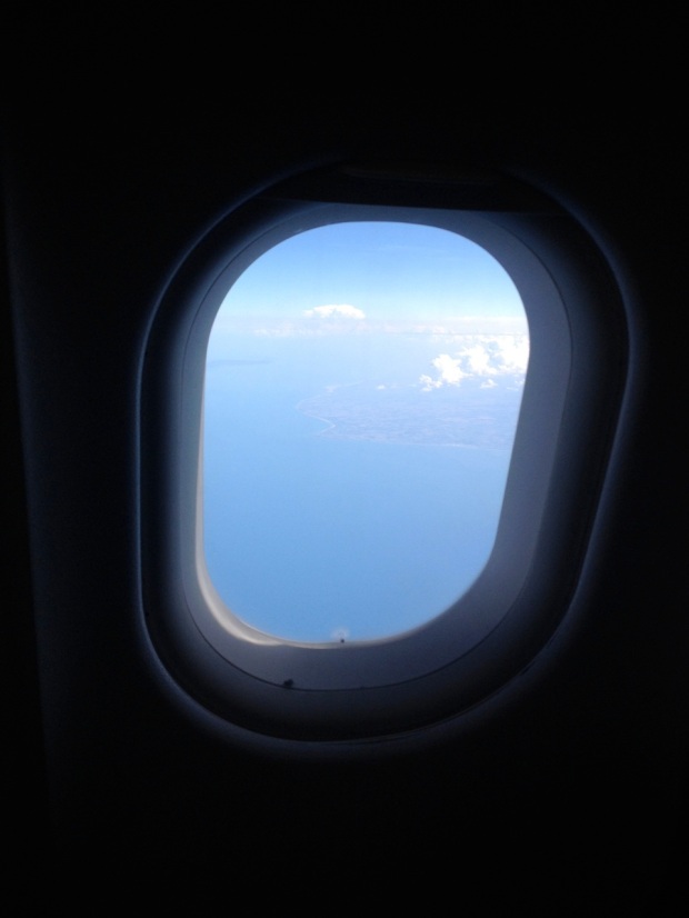 You can just make out the French coastline through the plane window.